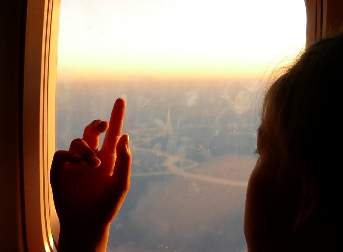 girl, hand, airplane window-878936.jpg