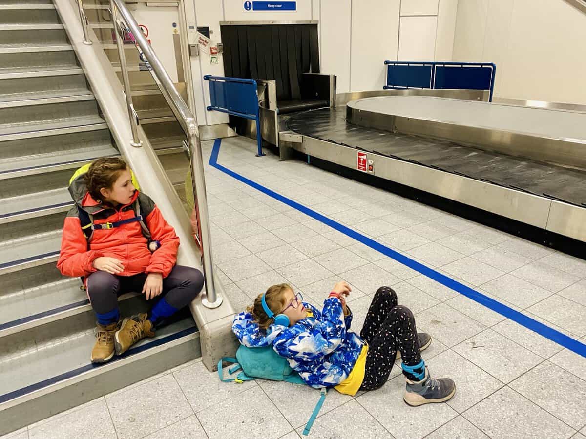 waiting for baggage at airport with kids