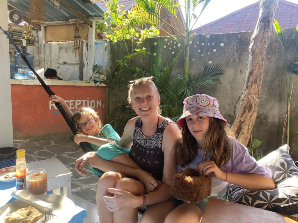 family in the Gili islands in a hammock eating breakfast